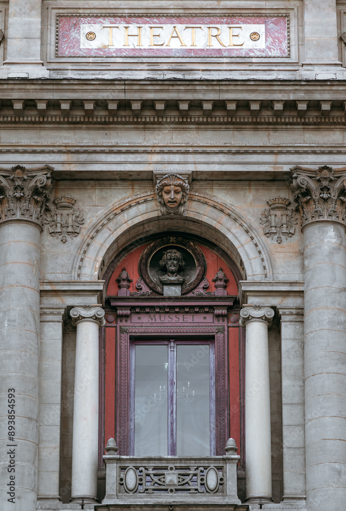 Admiring the exquisite facade of the Lyon Theater, with its tall red-framed windows, intricate stone sculptures, and elegant marble plaque. Admiring the exquisite facade of the Lyon Theater, with its tall red-framed windows, intricate stone sculptures, and elegant marble plaque.