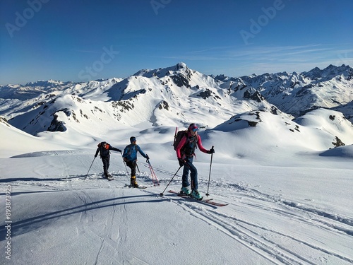 Ski touring group ascending to the Flüela Wisshorn in the mountains of Davos Klosters Mountains. Ski mountaineering in the Swiss mountains. Out and about in the mountains with friends. High.