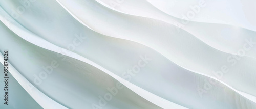 Soft, flowing white fabric waves create an elegant, serene scene, evoking feelings of calm and tranquility.