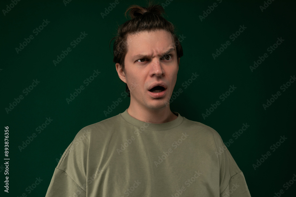 Man Making Surprised Face Against Green Background Man Making Surprised Face Against Green Background