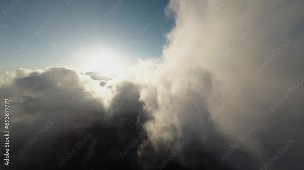 Aerial view Flying over the clouds timelapse with daytime sun. Flying through moving clouds with beautiful reflections. Air travel. Ideal for cinema, background Aerial view Flying over the clouds timelapse with daytime sun. Flying through moving clouds with beautiful reflections. Air travel. Ideal for cinema, background
