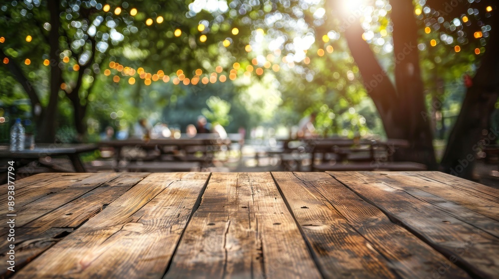 A rustic wooden tabletop with a blurred background of a summer backyard scene A rustic wooden tabletop with a blurred background of a summer backyard scene