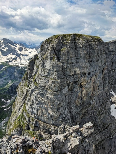 Via ferrata from Braunwald Glarus. Young men and women climbing the rock
climbs the rock up to the Eggstock mountain. Climbing in the Swiss mountains. High quality photo. photo