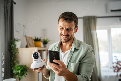 Fotografie Adult man at home connect install cctv security surveillance camera