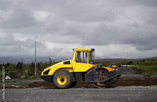 yellow asphalt roller is parked on the street in Reykjavik, Iceland, side view 