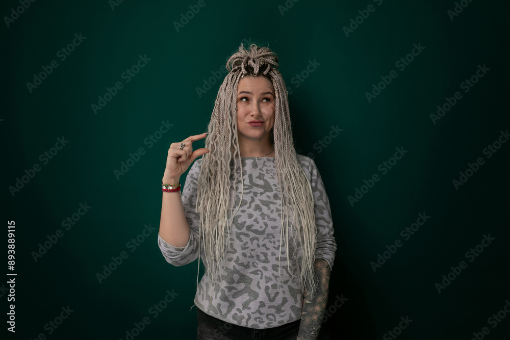 Woman With Long Blonde Hair Standing in Front of Green Wall Woman With Long Blonde Hair Standing in Front of Green Wall