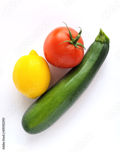 Zucchini, tomato and lemon isolated on white background 