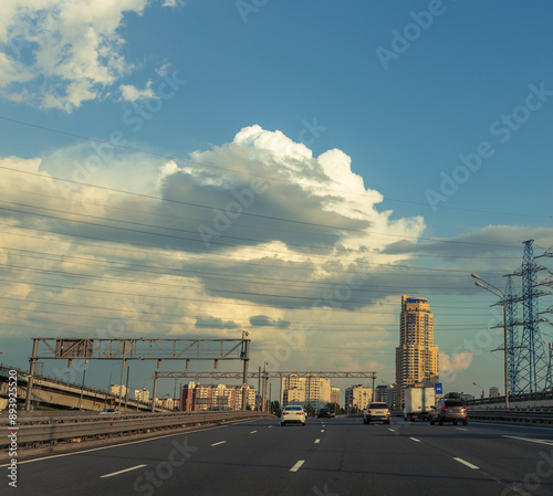 A busy highway with a large building in the background © Sergei