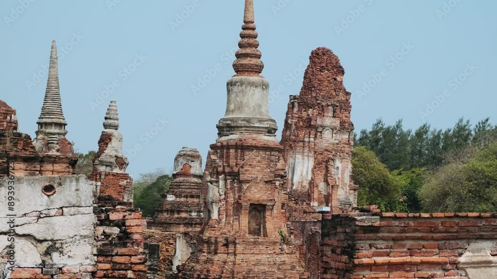 Wat Mahathat ancient temple in Ayutthaya historical park, Thailand, Asia. Historical Buddhist architecture on archaelogical site in ancient capital city of Siam under blue sky