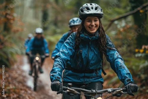 Woodland expedition: Mountain bikers venture into the heart of a lush forest, led by a smiling rider in blue.