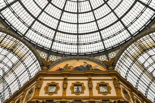 Detail of the iron and glass dome of the Galleria Vittorio Emanuele II historic shopping gallery, with a mosaic lunette depicting an allegory of Asia, Milan, Lombardy, Italy photo