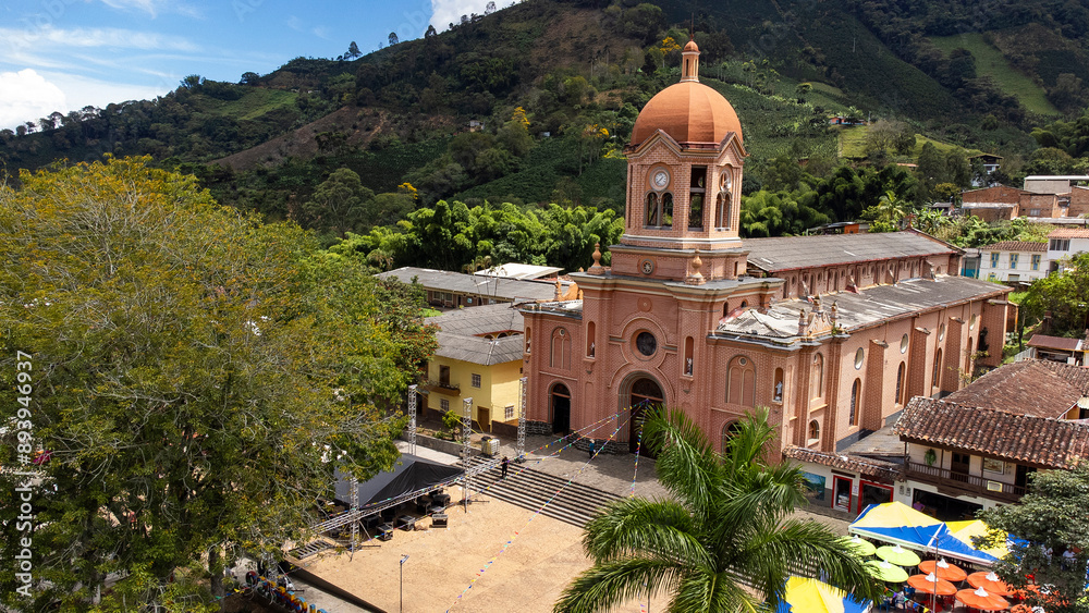 Fototapeta premium Pueblorrico, Antioquia - Colombia - July 21, 2024. Facade of the Catholic church located in the main park of the municipality.