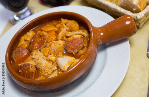 Popular Spanish Callos of tripe braised in sauce with chopped chorizo and chickpeas served in clay cazuela..