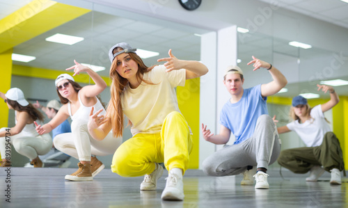 Boys and girls learn to dance modern dances in dance studio photo