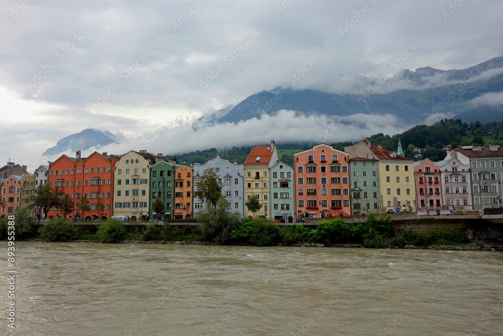 Obraz premium Clouds drift over Innsbruck, a city nestled in the Austrian Alps