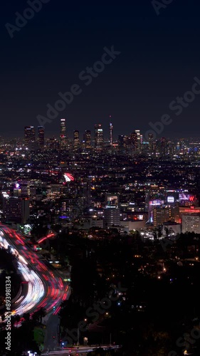 Hollywood and Los Angeles Downtown Skyline Night Traffic 2 Vertical