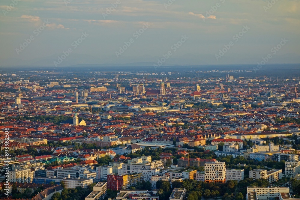 Fototapeta premium The Olympiaturm tower in Munich, Germany overlooks the city and the Bavarian Alps in the distance