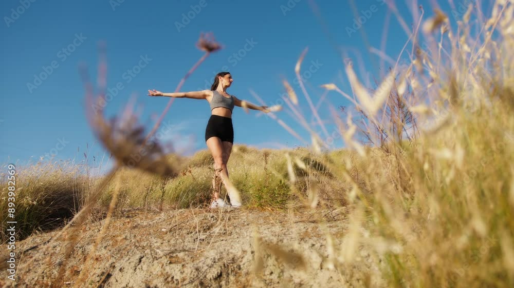 Caucasian Girl Dances Among The Plants On A Hill Outside Caucasian Girl Dances Among The Plants On A Hill Outside