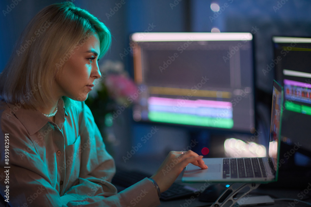 Professional Video Editor Working Late on Advanced Editing Software in Home Office Professional Video Editor Working Late on Advanced Editing Software in Home Office