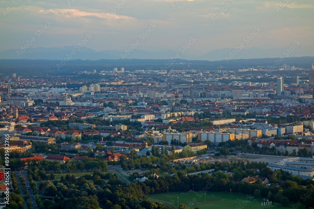 Obraz premium The Olympiaturm tower in Munich, Germany overlooks the city and the Bavarian Alps in the distance