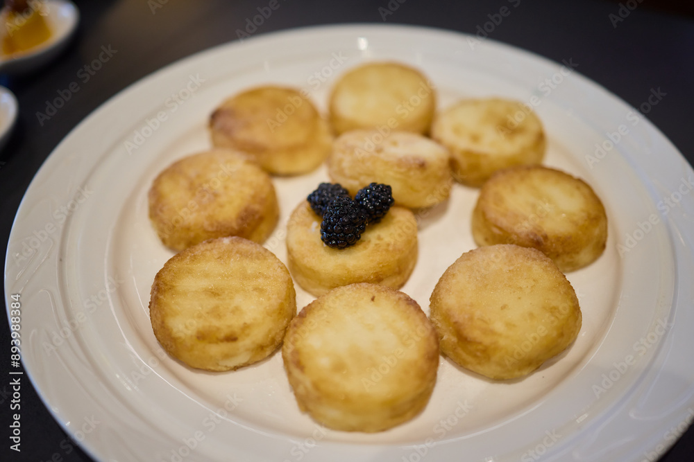 Fried potato rounds with caviar on a white plate can elevate your appetizer selection Fried potato rounds with caviar on a white plate can elevate your appetizer selection