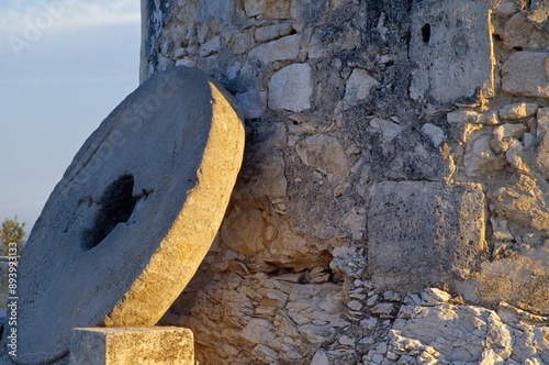 A Millstone Leaning Against A Windmill Wall photo