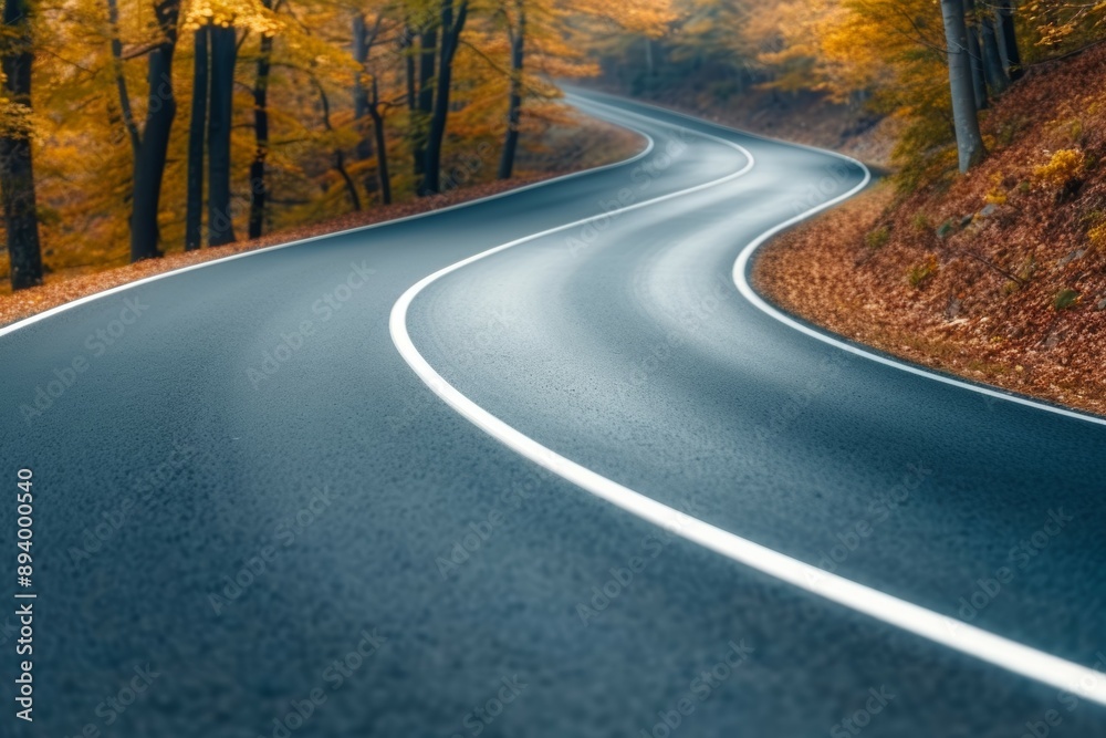 Naklejka premium A road with a curve and trees in the background
