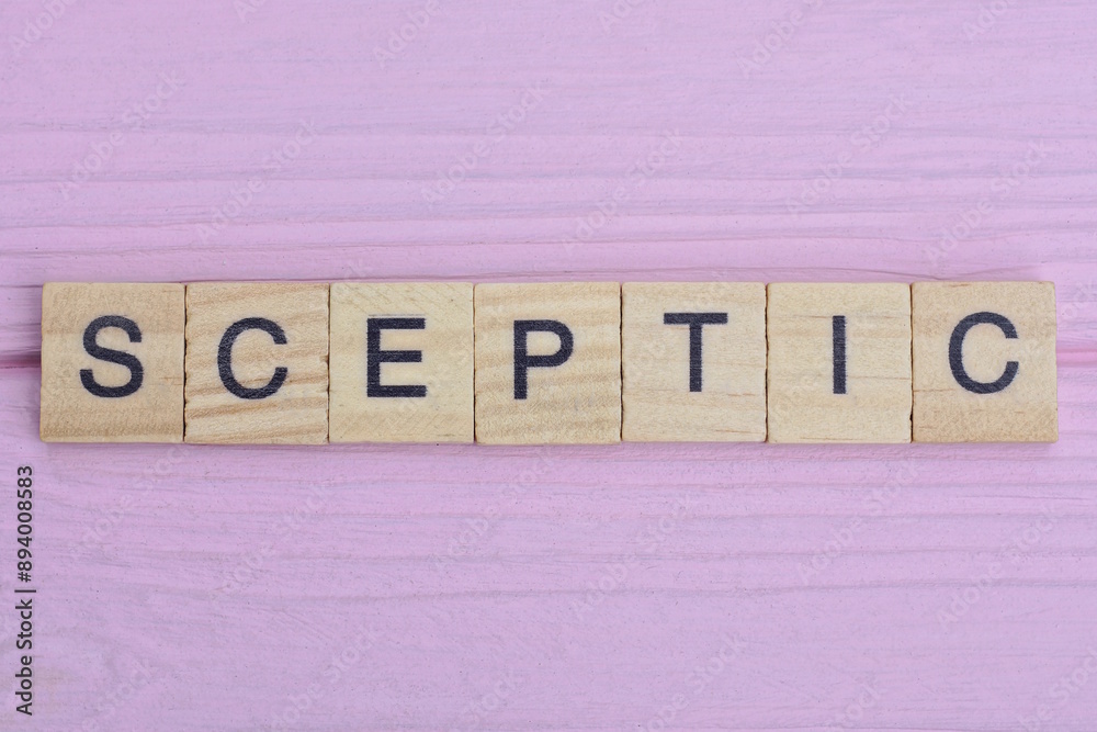 word sceptic from gray wooden small letters with black font on an pink background word sceptic from gray wooden small letters with black font on an pink background