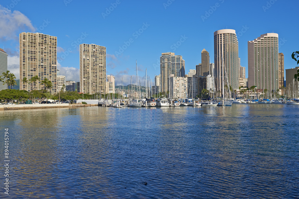 Obraz premium City, sea and sky with business architecture outdoor in Hawaii, USA for commercial or corporate trade. Background, infrastructure and nature with buildings in urban town for work in sunny environment
