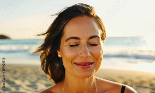 Happy 40 year old woman on the beach smiling with serenity