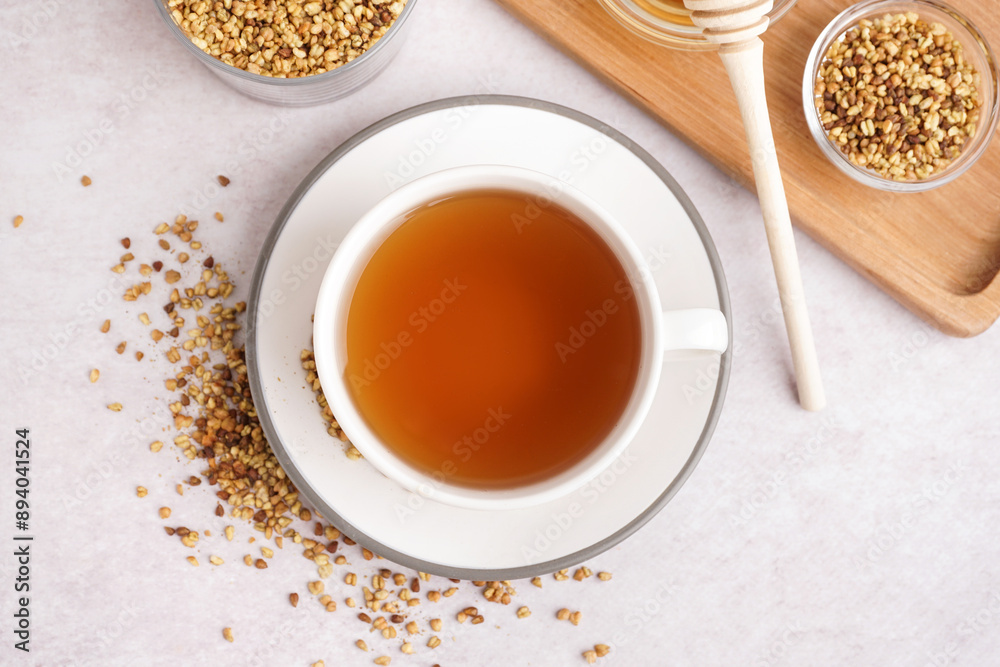 Cup of tasty fresh buckwheat tea on light background Cup of tasty fresh buckwheat tea on light background