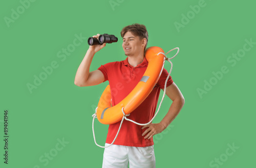 Male lifeguard with binocul...