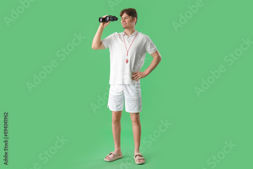 Male lifeguard with binocul...