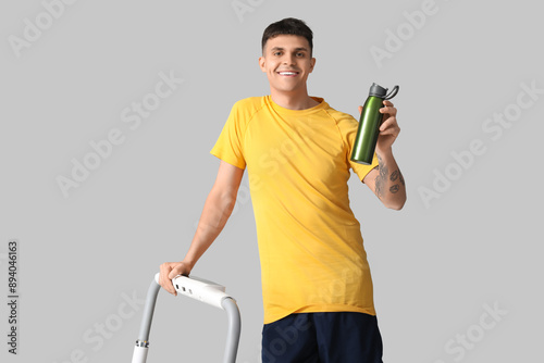 Sporty young man with bottl...