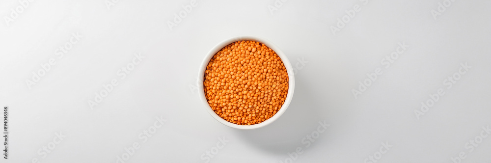Red lentils in a white bowl, showcasing their vibrant color and nutritional benefits, perfect for a healthy diet Red lentils in a white bowl, showcasing their vibrant color and nutritional benefits, perfect for a healthy diet