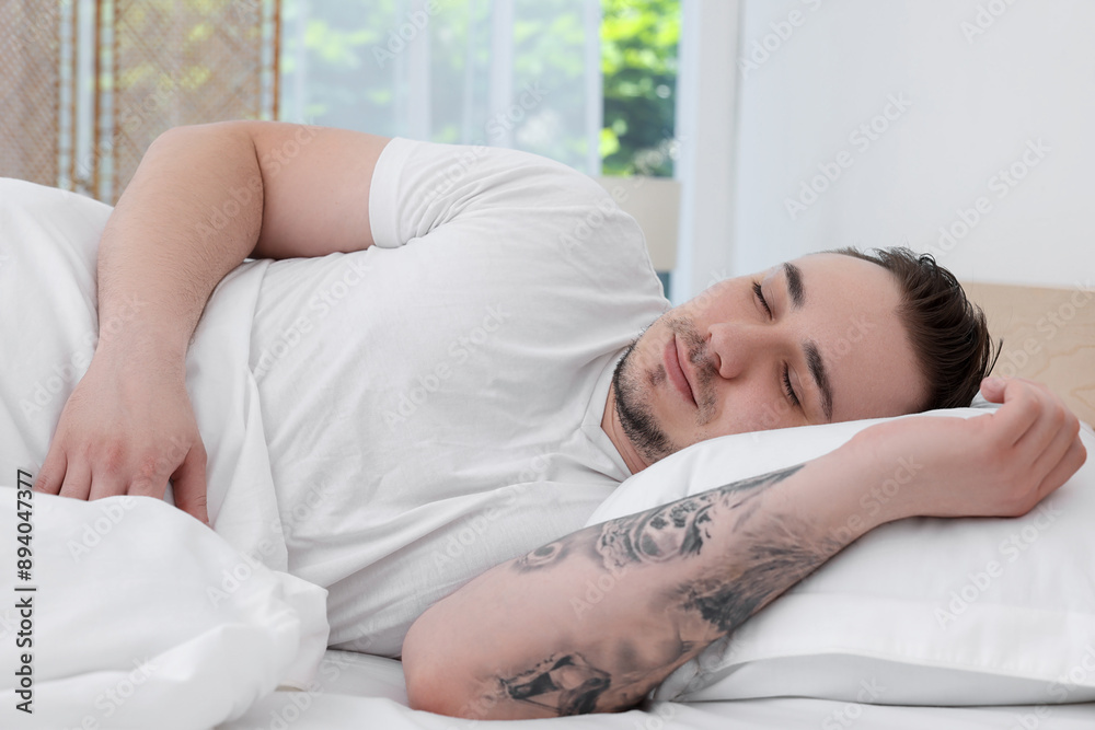 Bedtime. Handsome man sleeping in bed indoors Bedtime. Handsome man sleeping in bed indoors