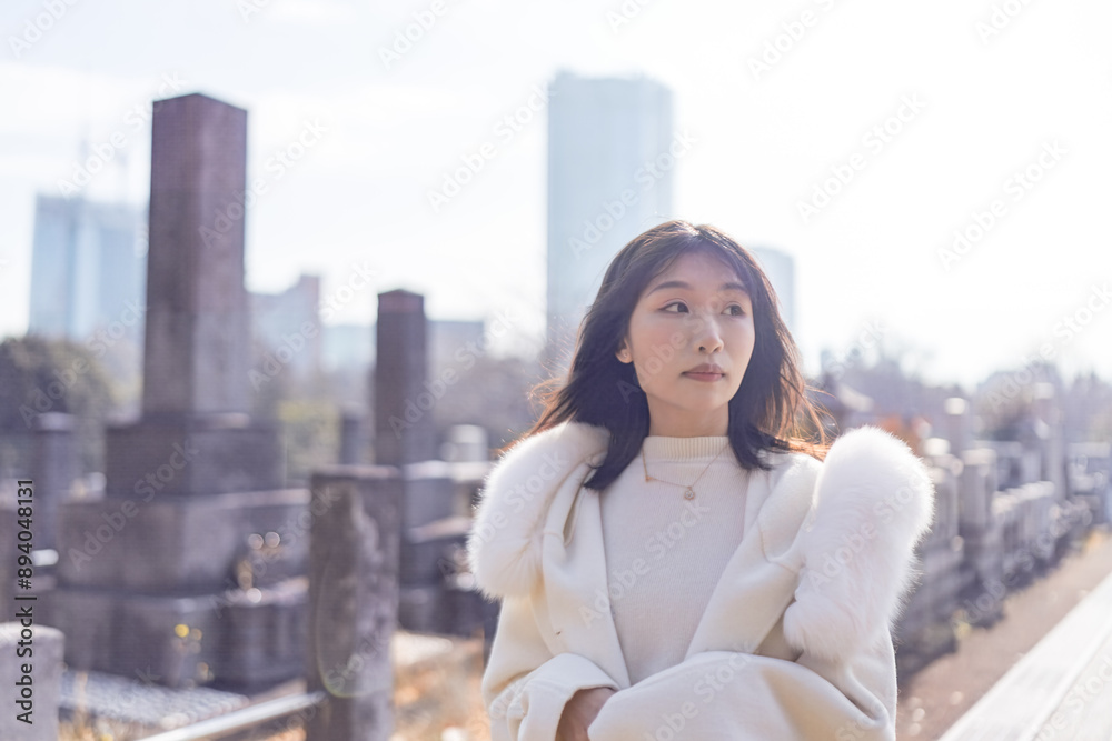 Twenty-something Chinese woman with black hair wearing a white coat with a fluffy fur hood and a white skirt walking on a public road in Minato, Tokyo, Japan. Twenty-something Chinese woman with black hair wearing a white coat with a fluffy fur hood and a white skirt walking on a public road in Minato, Tokyo, Japan.