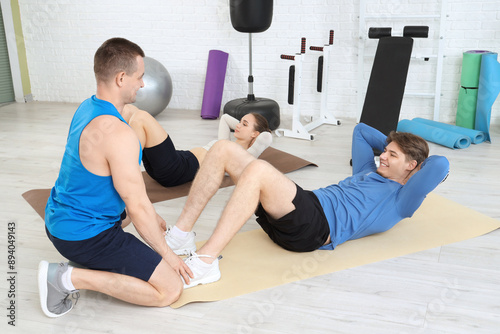Sporty young man doing abs ...