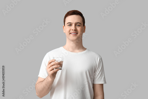 Smiling young man holding g...