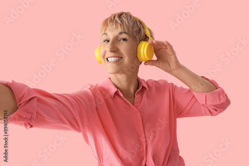 Mature woman in headphones ...