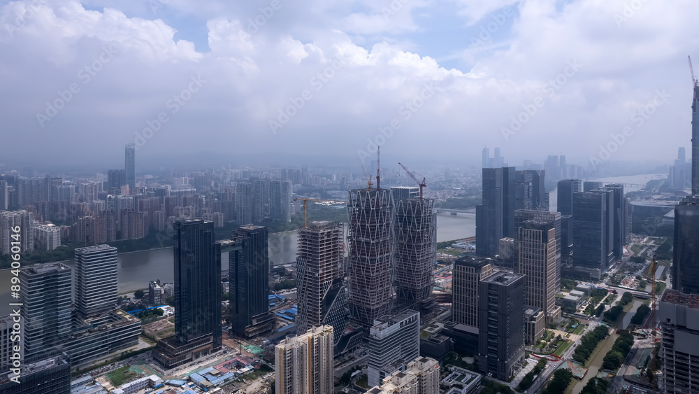 Aerial View of a Modern Urban Cityscape Under Cloudy Skies Aerial View of a Modern Urban Cityscape Under Cloudy Skies