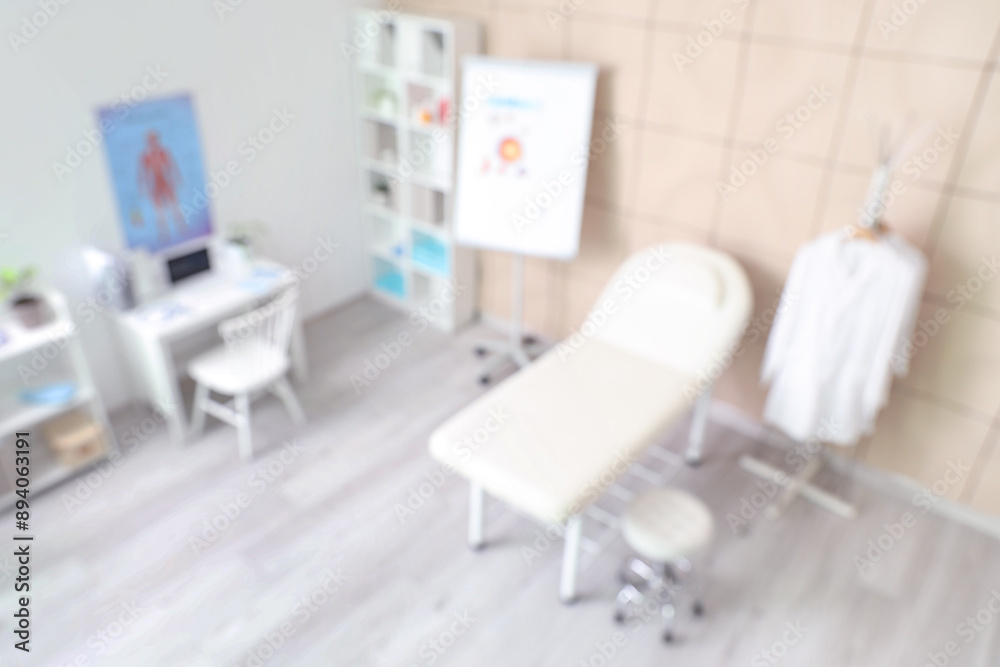 Blurred view of medical office with couch and doctor's workplace Blurred view of medical office with couch and doctor's workplace