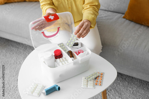 Woman putting pills in firs...