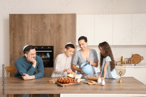 Jewish family preparing cha...