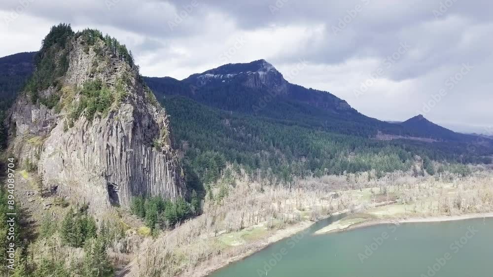 A drone shot of Beacon Rock in Washington captures the towering monolith amid lush forests and the Columbia River, offering a breathtaking, aerial view of this natural landmark A drone shot of Beacon Rock in Washington captures the towering monolith amid lush forests and the Columbia River, offering a breathtaking, aerial view of this natural landmark
