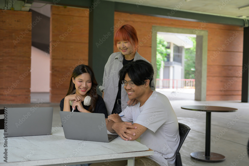 Group of Happy Students Collaborating on Laptops Outdoors in a Modern Campus Setting Group of Happy Students Collaborating on Laptops Outdoors in a Modern Campus Setting