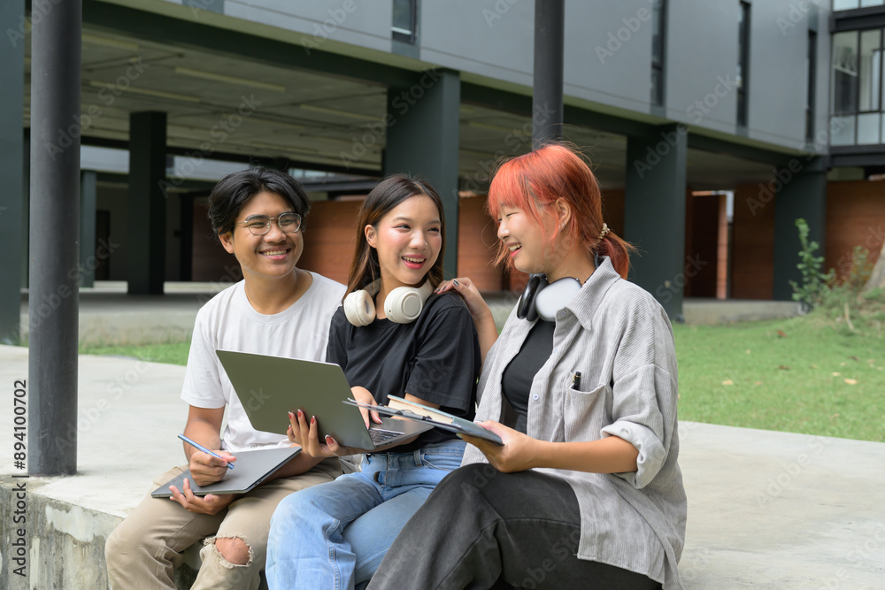 © Parichat - Group of Diverse Students Studying Outdoors with Laptops and Notebooks at Modern University Campus