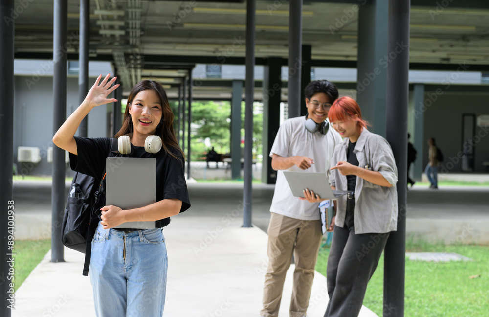 Group of Happy Students on Campus with Laptops and Headphones, Smiling and Waving, Outdoors in a Modern University Setting Group of Happy Students on Campus with Laptops and Headphones, Smiling and Waving, Outdoors in a Modern University Setting