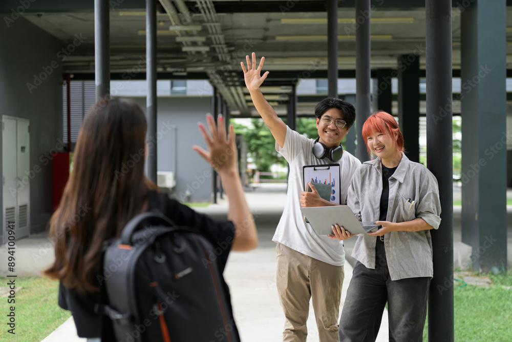 © Parichat - Happy Students Waving and Greeting Each Other on a Modern College Campus Outdoors