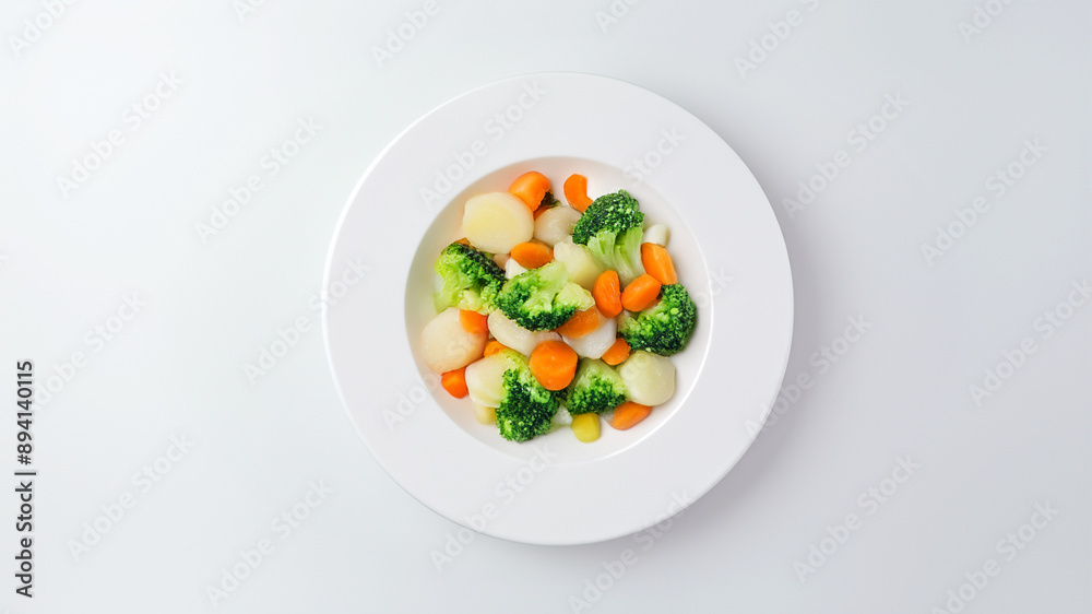 Steamed mixed vegetables including broccoli, carrots, and cauliflower, served on a white plate, showcasing a healthy and colorful side dish, perfect for a balanced meal, set against a clean white bac Steamed mixed vegetables including broccoli, carrots, and cauliflower, served on a white plate, showcasing a healthy and colorful side dish, perfect for a balanced meal, set against a clean white bac